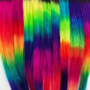 Neon rainbow clip-in human hair extensions in vivid pink, orange, green, blue, and purple vertical streaks.